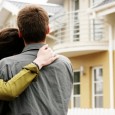 couple in front of one-family house in modern residential area couple in front of one-family house in modern residential area